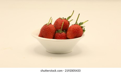 Strawberries Are Placed In A Small White Plate.