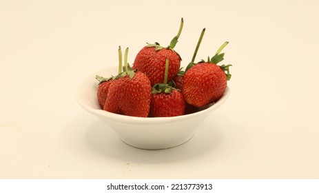 Strawberries Are Placed In A Small White Plate.