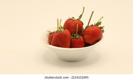 Strawberries Are Placed In A Small White Plate.