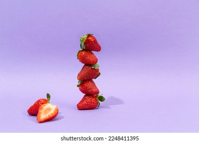 strawberries stacked on colorful background - Shutterstock ID 2248411395