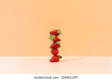strawberries stacked on colorful background - Shutterstock ID 2248411397