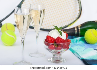 Strawberries With Whipped Cream And Champagne, Tennis Racket And Balls On Table In Background