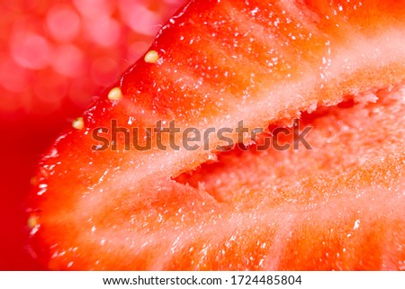 Strawberry background. Blurred natural red background. Texture of strawberry berries. Beautiful sliced strawberries close-up. Horizontal, close-up, nobody. Healthy eating concept.