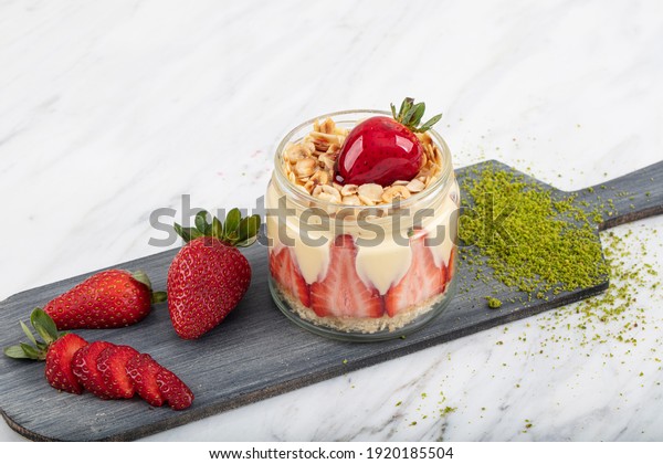 strawberry and banana magnolia dessert
in the cup tree magnolia on the light marble
background.