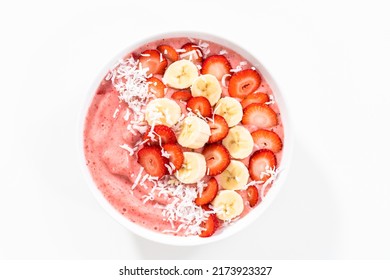 Strawberry And Banana Smoothie Bowl Garnished With Coconut Flakes And Fresh Fruits.