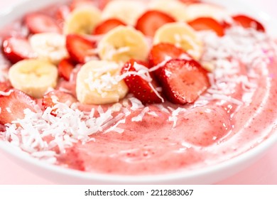 Strawberry And Banana Smoothie Bowl Garnished With Coconut Flakes And Fresh Fruits.