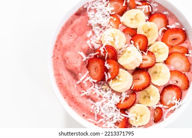 Strawberry And Banana Smoothie Bowl Garnished With Coconut Flakes And Fresh Fruits.