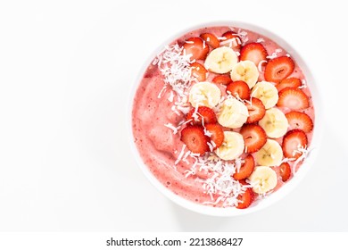 Strawberry And Banana Smoothie Bowl Garnished With Coconut Flakes And Fresh Fruits.