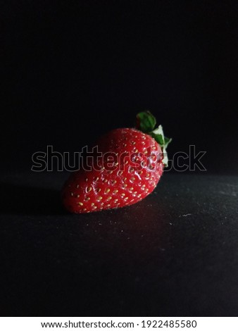 a strawberry and black background 