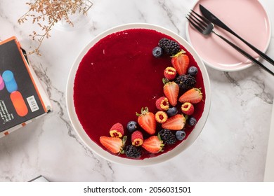 Strawberry And Blueberry Cake On White Marble 