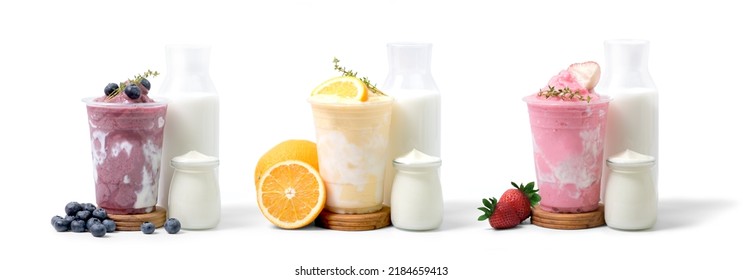 Strawberry, Blueberry And Orange Yogurt Smoothie With Strawberry, Blueberry And Orange Fruit,yogurt Bottle And Milk Bottle Isolated On White Background. Coffee Shop Cafe Menu Concept.