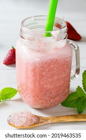 Strawberry Boba Smoothie, In A Glass With A Green Straw On A White Table