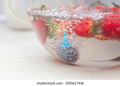 Strawberry In A Bowl With Water With A Round Ozonating Stone. Tubes Leading To Oxygen Pump And Ozone Generator. Ozonation Fruit. Food Disinfection With Ozon