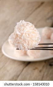 Strawberry Champagne Truffle With Coconut Flakes On A Praline Fork