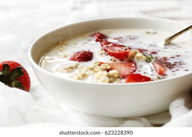 Strawberry Chia Overnight Oats Served In A White Bowl, Selective Focus