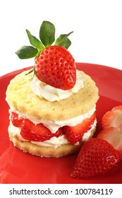 Strawberry and cream shortcake on a red plate