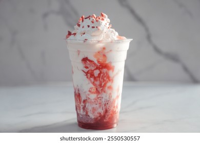 strawberry creme frappe on a white marble background