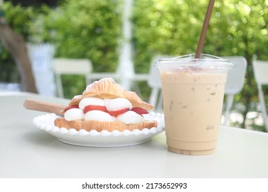 Strawberry Croissant And Ice Coffee On Table In The Garden