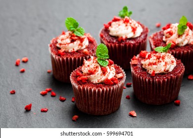 Strawberry  cupcakes with butter cream on black stone background  - Powered by Shutterstock