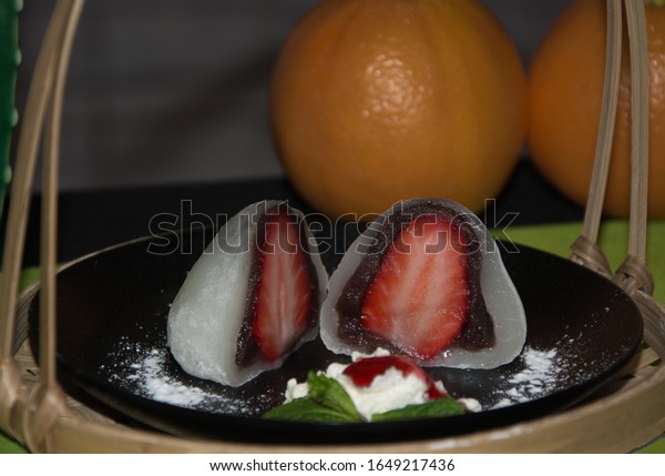 Strawberry\
dessert divided in half in wicker\
basket