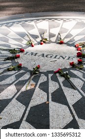 Strawberry Fields, New York City, NY - September 11 2012: Memorial mosaic saying Imagine at Central Park with roses to remember former Beatles member John Lennon who was shot at nearby Dakota Building