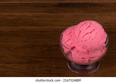 Strawberry Flavored Ice Cream Served In A Glass Bowl With Empty Space On The Left For Texts.