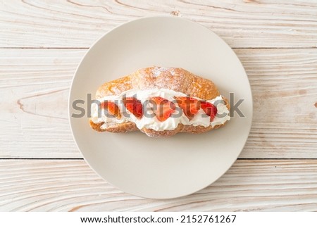 strawberry and fresh cream croissant on plate