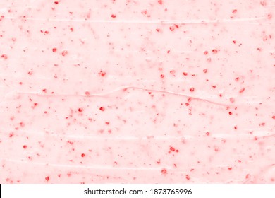 Strawberry frozen yogurt background close up. Strawberry ice cream texture close up. Top view. Pink fruit ice cream background with small pieces of berries