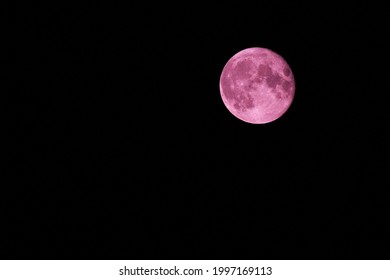 Strawberry Full Moon in the night sky.