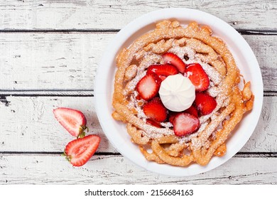 Strawberry Funnel Cake Overhead View On A White Wood Background. Traditional Summer Fair Treat.