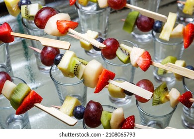 Strawberry, Grape, Apple, Pear And Kiwi Canapes On Wooden Skewers. Fruit Platter. Selective Focus. The Concept Of Public Catering.