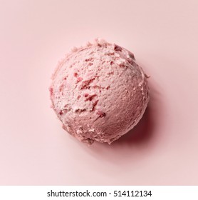 strawberry ice cream ball on pink background, top view