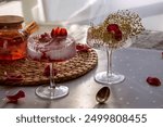 Strawberry Ice Cream in Glass Ice Cream Bowl. Water Hyacinth Placemat. Rose petals and blooming elderberries. Champagne coupe glass. Glass ice cream bowl. White satin tablecloth.