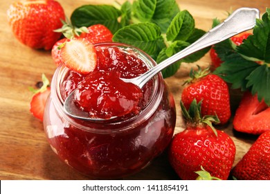 Strawberry Jam With Fresh Strawberries And Mint. Marmalade On Spoon And Jar On Wood