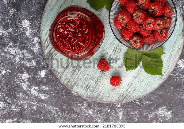 Strawberry jam in glass jar with fresh berries,\
Delicious strawberry jam and fruits on grey table, Homemade Jar of\
strawberry confitur on marble background from top view copy space,\
close up breakfast
