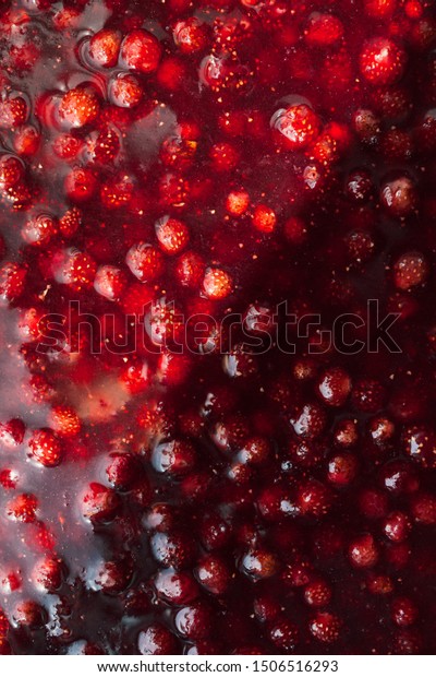strawberry jam texture divided in half by a\
solar flare, food background\
vertical