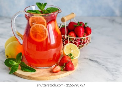 Strawberry lemon lemonade with mint in jug. Summer refreshing drink.  Detox fruit water. Selective focus. Copy space