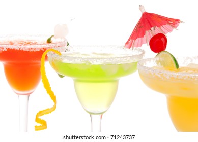 Strawberry, Lime, Peach Margaritas Cocktails Composition Decorated With Twisted Orange,  Lime, Mint, Cherry, Cocktail Umbrella In Margarita Glass Isolated On A White Background