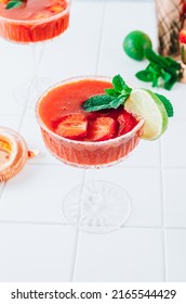 Strawberry Margarita Or Daiquiri Cocktail With Lime And Mint On White Background. Frozen Homemade Strawberry Summer Cocktail. Selective Focus