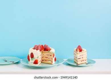 Strawberry Mascarpone Cake.  Layered with a fresh strawberry and mascarpone whipped cream. It’s the perfect combination for a strawberries and cream cake. Blue wall. 