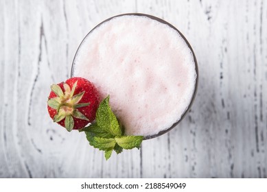 Strawberry milkshake on an old white table close up, top view - Shutterstock ID 2188549049