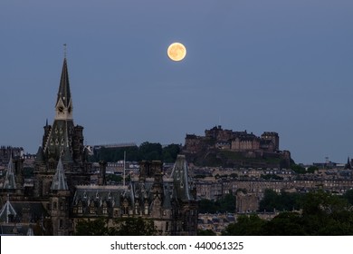Strawberry moon on summer solstice over Edinburgh Castle, Scotland