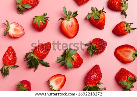 Strawberry on pink background, top view. Berries pattern. Strawberry flat lay on  pink background.
