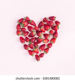 Strawberry pattern. Heart symbol made of strawberry on pink background. Flat lay, top view, square
