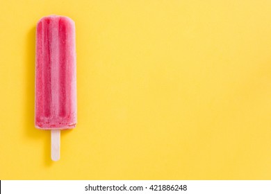 Strawberry Popsicle On Yellow Background
