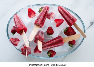 Strawberry Popsicles Lies On Ice With Strawberries. Flatlay, Selective Focus, Blurred Background