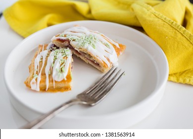 Strawberry Poptart With Icing And Green Sprinkles On White Background