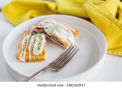 Strawberry Poptart With Icing And Green Sprinkles On White Background