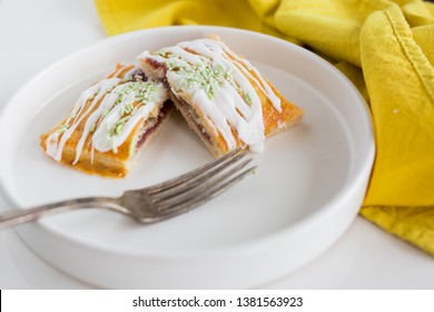 Strawberry Poptart With Icing And Green Sprinkles On White Background