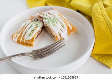 Strawberry Poptart With Icing And Green Sprinkles On White Background